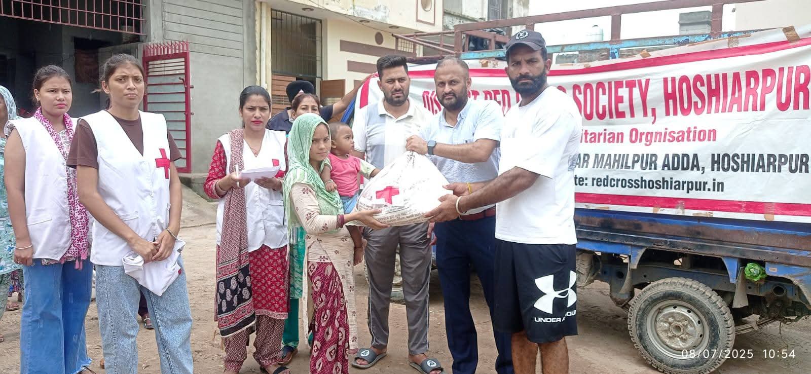 Red Cross distributes relief materials to rain-affected families in Shanti Nagar.